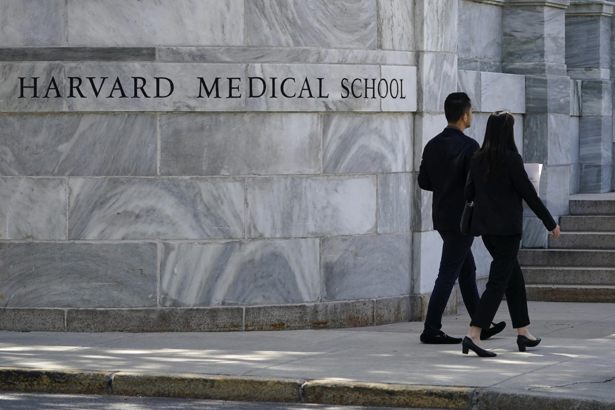 FILE - Pedestrians walk towards the Harvard Medical School, Thursday, Aug. 18, 2022, in Boston. On Friday, Jan. 20, 2023, The Associated Press reported on stories circulating online incorrectly claiming a class at Harvard Medical School trains students to treat transgender infants. (AP Photo/Charles Krupa, File)