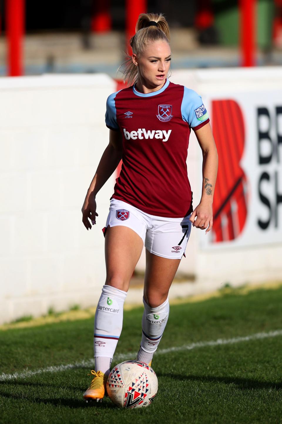 DAGENHAM, ENGLAND - NOVEMBER 15: Alisha Lehmann of West Ham United runs with the ball during the Barclays FA Women's Super League match between West Ham United Women and Brighton & Hove Albion Women at Chigwell Construction Stadium on November 15, 2020 in Dagenham, England. Football Stadiums around Europe remain empty due to the Coronavirus Pandemic as Government social distancing laws prohibit fans inside venues resulting in fixtures being played behind closed doors. (Photo by James Chance/Getty Images)