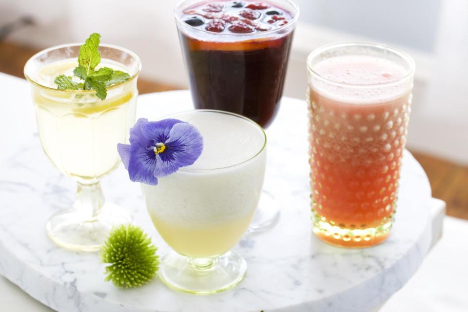 In this image taken on April 22, 2013, summer cocktails, clockwise from top, Trashy Red Wine Sangria, Vodka Watermelon Slushie, Pisco Sour and Gin and Bitter Lemon are shown in Concord, N.H. (AP Photo/Matthew Mead)