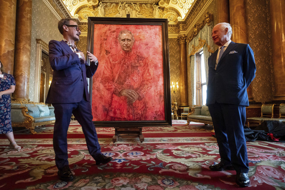 Artist Jonathan Yeo, left, and Britain's King Charles III at the unveiling of artist Yeo's portrait of the King, in the blue drawing room at Buckingham Palace, in London, Tuesday May 14, 2024. The portrait was commissioned in 2020 to celebrate the then Prince of Wales's 50 years as a member of The Drapers' Company in 2022. The artwork depicts the King wearing the uniform of the Welsh Guards, of which he was made Regimental Colonel in 1975. The canvas size - approximately 8.5 by 6.5 feet when framed - was carefully considered to fit within the architecture of Drapers' Hall and the context of the paintings it will eventually hang alongside. (Aaron Chown/Pool Photo via AP)
