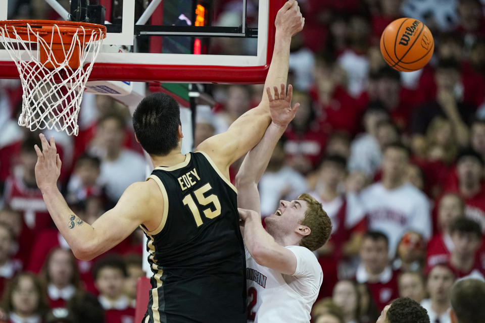 Purdue's Zach Edey (15) blocks a shot by Wisconsin's Steven Crowl (22) during the first half of an NCAA college basketball game Sunday, Feb. 4, 2024, in Madison, Wis. (AP Photo/Andy Manis)