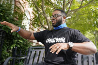 Devon Henry, owner of Henry Enterprises, gestures during an interview Tuesday Sept. 15, 2020, in Richmond, Va. Change came to Richmond’s historic Monument Avenue this summer at whiplash speed when the city’s mayor invoked emergency powers and ordered the removal of Confederate statues that had towered over the city for around a century. Behind the scenes was Devon Henry, the Black businessman whose construction company took on a job the city says others were unwilling to do and as a result has found himself facing death threats, allegations of cronyism and an inquiry by a special prosecutor. (AP Photo/Steve Helber)