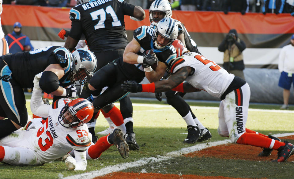 Carolina Panthers running back Christian McCaffrey (22) scores a 1-yard touchdown during the first half of an NFL football game against the Cleveland Browns, Sunday, Dec. 9, 2018, in Cleveland. (AP Photo/Ron Schwane)