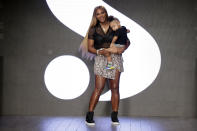 FILE - Serena Williams holds her daughter Alexis Olympia Ohanian Jr. after showing her clothing line during New York's Fashion Week in New York. Serena Williams says she is ready to step away from tennis after winning 23 Grand Slam titles, turning her focus to having another child and her business interests. “I’m turning 41 this month, and something’s got to give,” Williams wrote in an essay released Tuesday, Aug. 9, 2022, by Vogue magazine. (AP Photo/Seth Wenig, File)