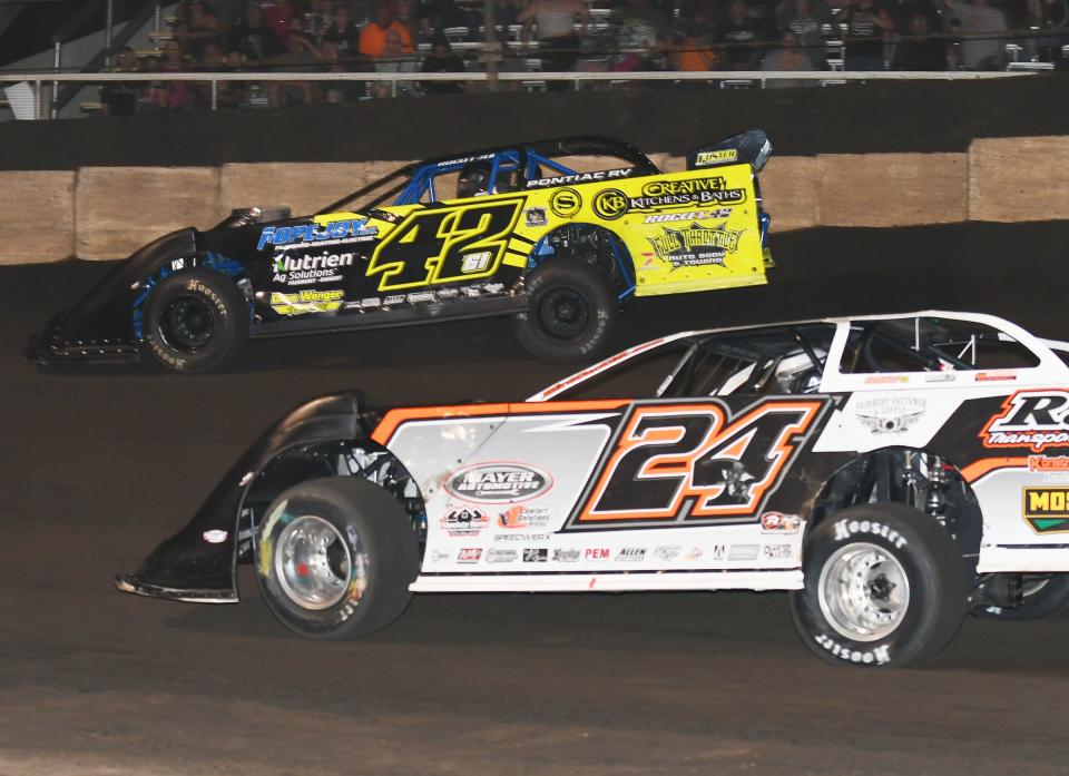 McKay Wenger (42) and Ryan Unzicker ran side by side for the lead before Unzicker took command and charged to victory in the late model feature Saturday at Fairbury Speedway.