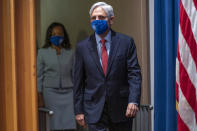 Attorney General Merrick Garland and Assistant Attorney General for Civil Rights Kristen Clarke, left, arrives for a news conference at the Department of Justice in Washington, Thursday, Aug. 5, 2021, to announce that the Department of Justice is opening an investigation into the city of Phoenix and the Phoenix Police Department. (AP Photo/Andrew Harnik)