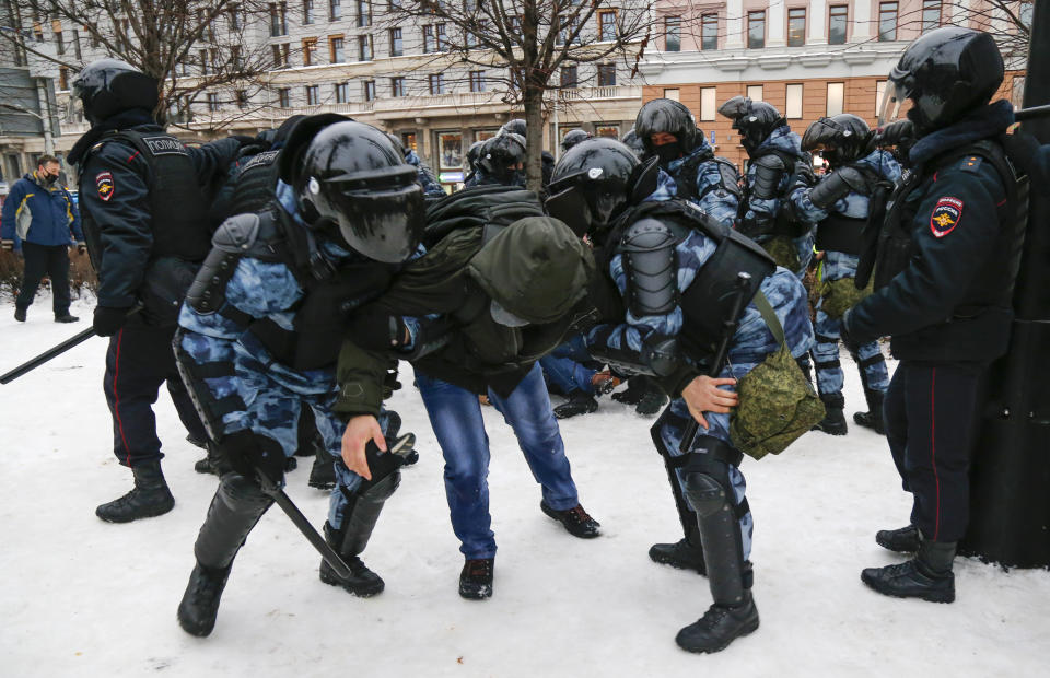 Police detain a man during a protest against the jailing of opposition leader Alexei Navalny in Moscow, Russia, Saturday, Jan. 23, 2021. Russian police on Saturday arrested hundreds of protesters who took to the streets in temperatures as low as minus-50 C (minus-58 F) to demand the release of Alexei Navalny, the country's top opposition figure. A Navalny, President Vladimir Putin's most prominent foe, was arrested on Jan. 17 when he returned to Moscow from Germany, where he had spent five months recovering from a severe nerve-agent poisoning that he blames on the Kremlin. (AP Photo/Alexander Zemlianichenko)