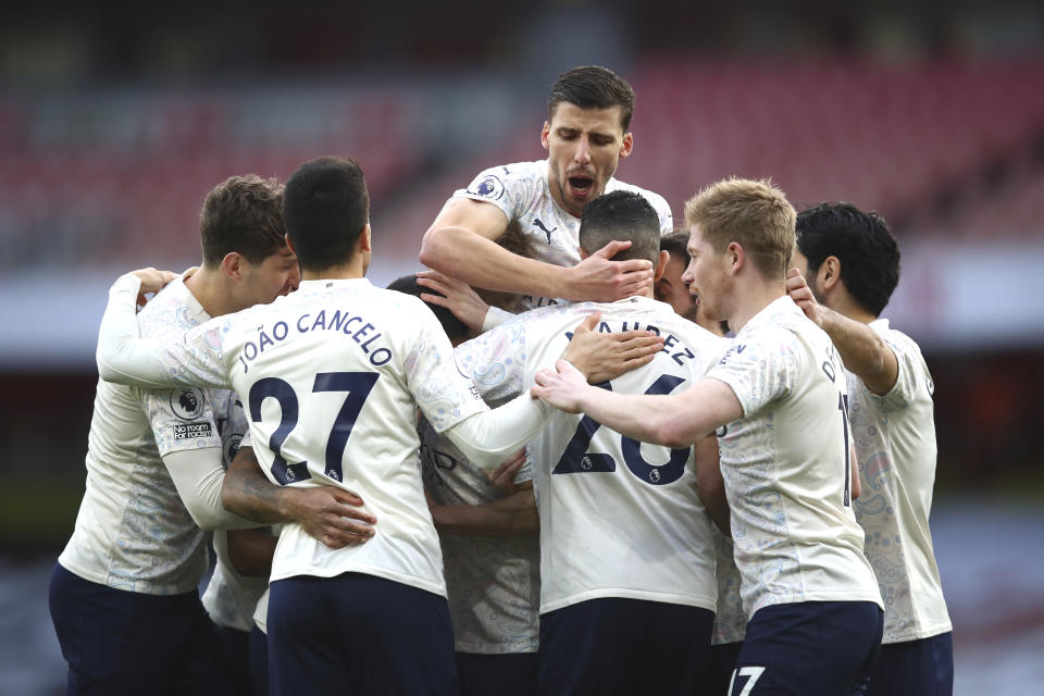 Manchester City players celebrate after Manchester City's Raheem Sterling scored his side's opening goal during the English Premier League soccer match between Arsenal and Manchester City at the Emirates stadium in London, England, Sunday, Feb. 21, 2021. (Julian Finney/Pool via AP)