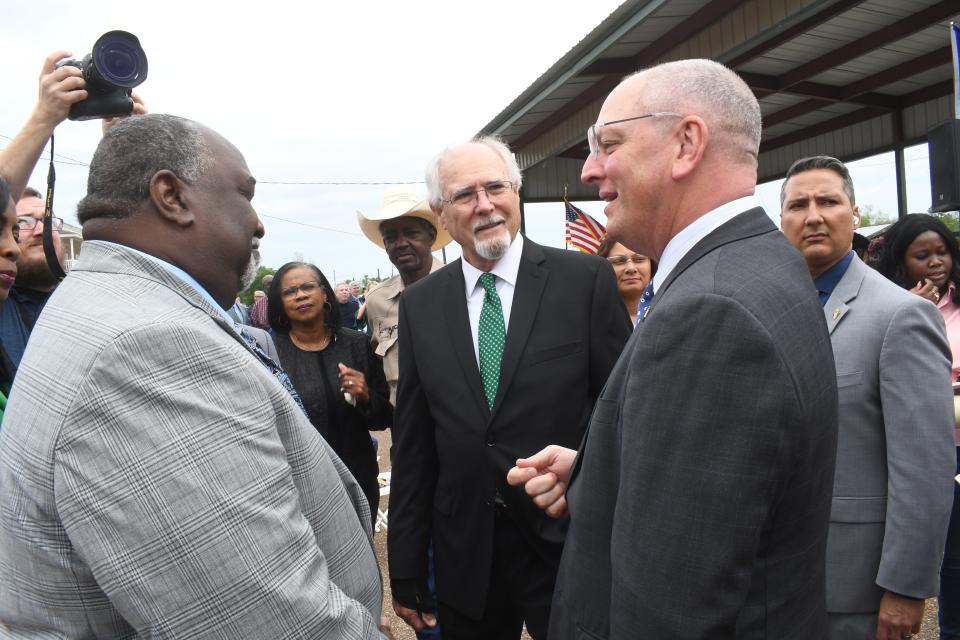 The Rev. Avery Hamilton (left) and Dean Woods (center) talk with Gov. John Bel Edwards at the unveiling ceremony for the Colfax Massacre Memorial held Thursday. Hamilton is the descendant of one of the victims of the Colfax Massacre that happened April 13, 1873. Woods is a descendants of one of the men who perpetrated the massacre that killed 60-80 Black men on Easter Sunday in 1873.