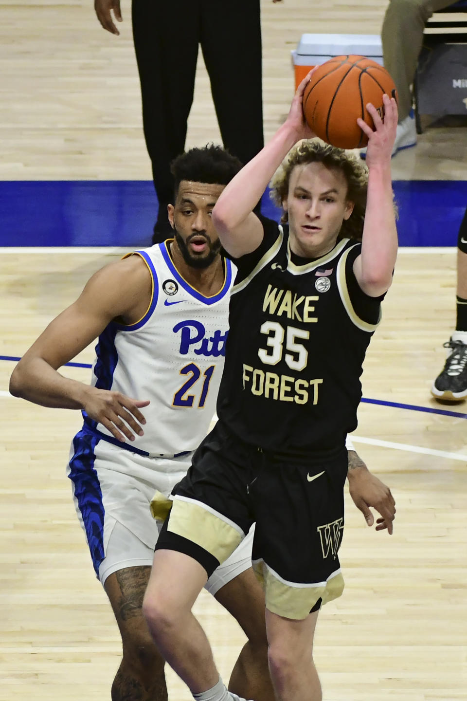 Wake Forest forward Carter Whitt drives past Pittsburgh forward Terrell Brown during the first half of an NCAA college basketball game, Tuesday, March 2, 2021, in Pittsburgh. (AP Photo/Fred Vuich)