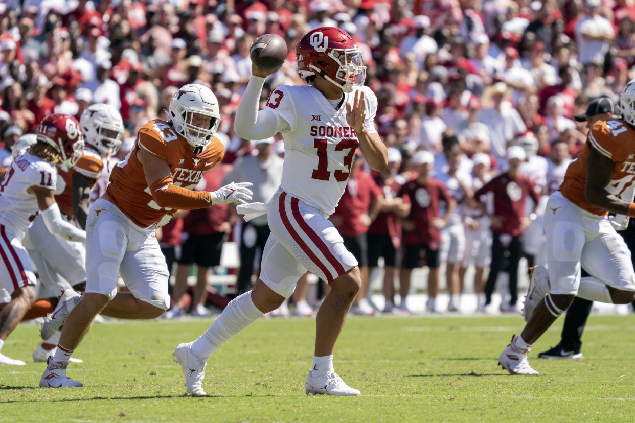 Oklahoma quarterback Caleb Williams (13) looks to pass during the first half of an NCAA college football game against Texas at the Cotton Bowl, Saturday, Oct. 9, 2021, in Dallas. (AP Photo/Jeffrey McWhorter)