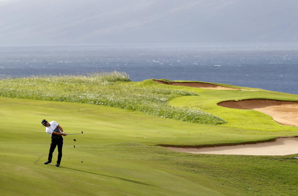 Gary Woodland hits from the 13th fairway during the second round of the Tournament of Champions golf event, Friday, Jan. 4, 2019, at Kapalua Plantation Course in Kapalua, Hawaii. (AP Photo/Matt York)