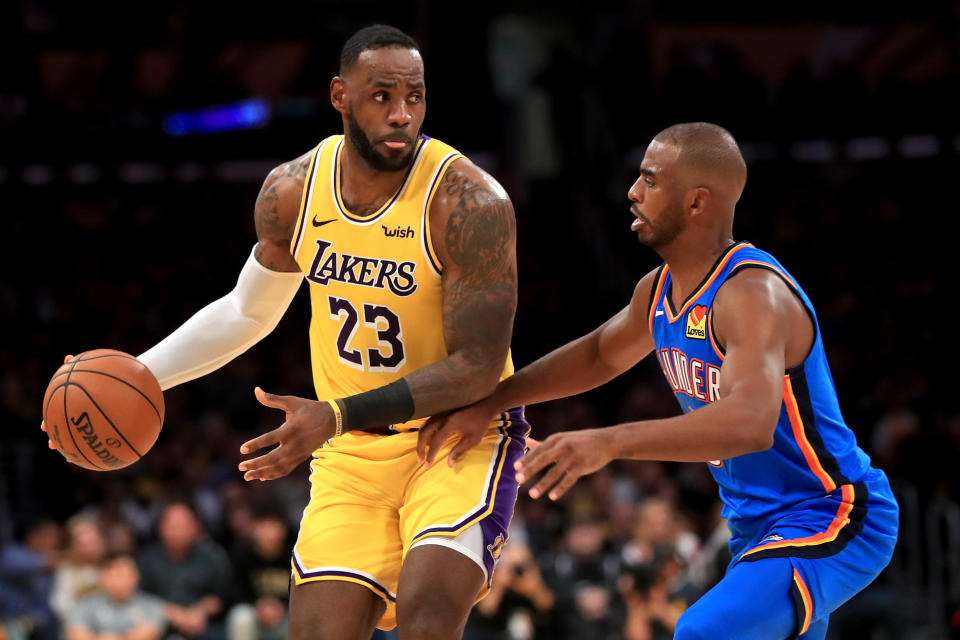 Old friends LeBron James and Chris Paul meet again with their latest set of weapons around them. (Sean M. Haffey/Getty Images)