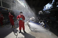 A firemen spray disinfectant to curb the spread of the coronavirus at the Tanah Abang textile market in Jakarta, Indonesia, Thursday, June 4, 2020. Authorities in Indonesia's capital will ease a partial lockdown as the world's fourth most populous nation braces to gradually reopen its economy. (AP Photo/Dita Alangkara)