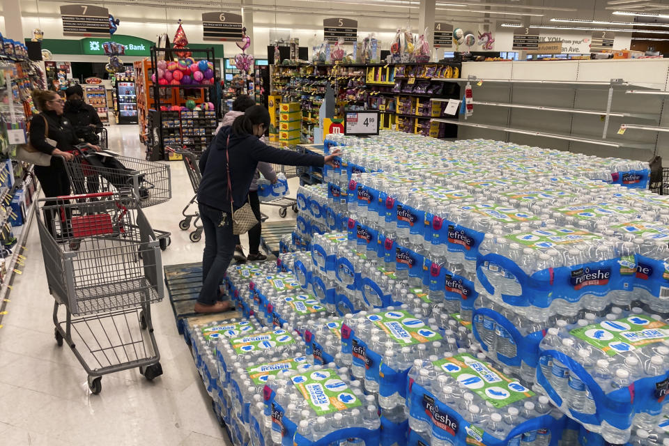 Shoppers stock up on bottle water following a chemical spill into the Delaware River upstream from Philadelphia, Tuesday, March 28, 2023. Health officials in Bucks County, just north of Philadelphia, said Sunday that thousands of gallons of a water-based latex finishing solution spilled into the river late Friday due to a leak at the Trinseo Altuglas chemical facility in Bristol Township. (AP Photo/Matt Rourke)