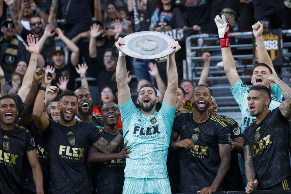 FILE - Los Angeles FC goalkeeper Maxime Crepeau, center, holds up the Supporters' Shield trophy in an awards ceremony after an MLS soccer match against Nashville SC, on Oct. 9, 2022, in Los Angeles. Crépeau is almost fully healed from the broken leg that sent him to the hospital deep into extra time at the MLS Cup final late last year. He hopes to play again before June 2023. (AP Photo/Ringo H.W. Chiu, File)