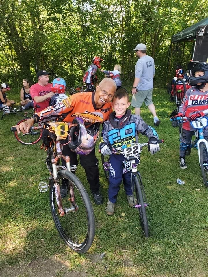 Kittie Weston-Knauer with Brysen Bolger, 9, at a BMX competition. Brysen lost his siblings and father in a tornado that passed through central Iowa March 5.