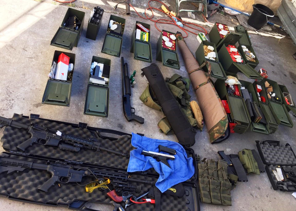 FILE - This undated file photo released Wednesday, Aug. 21, 2019 by the Long Beach, Calif., Police Department shows weapons and ammunition seized from a cook at a Los Angeles-area hotel who allegedly threatened a mass shooting. There’s been a big increase in the number of tips to U.S. law enforcement about potential mass shootings following the three shootings in August that killed 34 people. Experts say media coverage of the shootings makes the public more prone to inform on worrisome relatives or neighbors in attempts to prevent more shootings. Following the high-profile shootings in California and Texas and Ohio, tips to the FBI rose by about 15,000 each week. (Long Beach Police Department via AP, File)