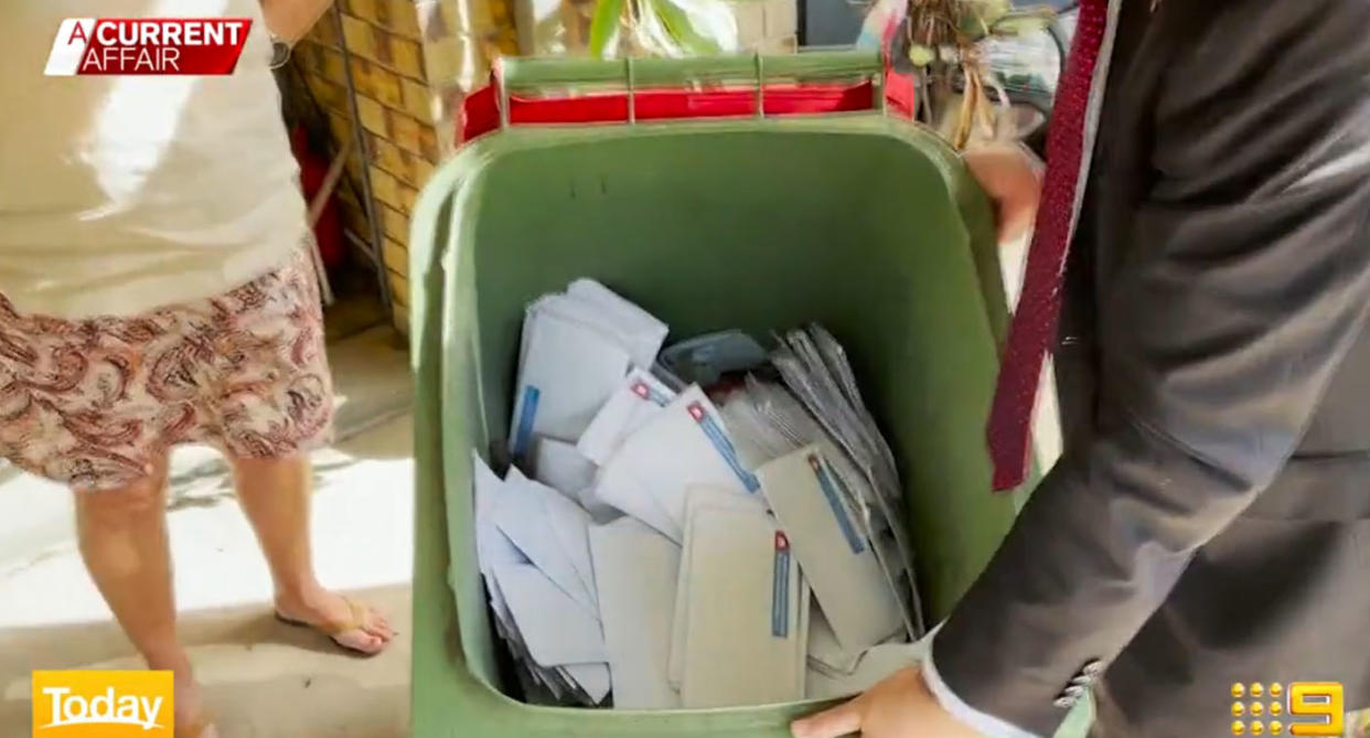 Wheelie bin full of electoral letters that were dumped.