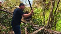 <p>Oscar Vazquez uses a machete to cut fallen branches from trees knocked over by Hurricane Maria at his family’s farm in Hatillo, Puerto Rico. (Photo: Caitlin Dickson/Yahoo News) </p>