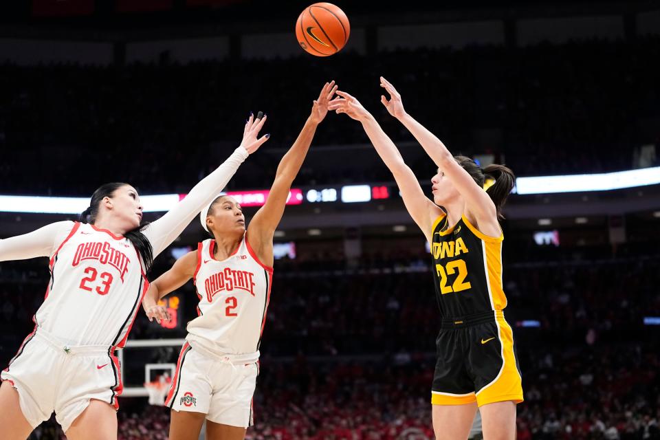 Iowa guard Caitlin Clark shoots over Ohio State's Rebeka Mikulasikova (23) and guard Taylor Thierry on Sunday.