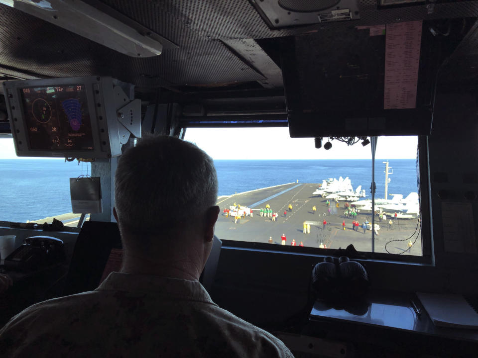 Marine Gen. Frank McKenzie, top U.S. commander for the Middle East, watches flight operations on board the USS Harry S. Truman, Saturday, Feb. 1, 2020, in the North Arabian Sea. Nearly a month after Iran launched a rare direct military attack against United States forces in Iraq, an uneasy quiet has settled across the region. Watching fighter jets roar off the flight deck of the USS Harry S. Truman, the top U.S. commander for the Middle East believes he is surrounded by one of the reasons that Iran has dialed back it's combat stance, at least for now. He says the presence of an aircraft carrier make a potential adversary think twice about war. But he and other commanders on the ship agree that deterrence is hard to measure. (AP Photo/Lolita Baldor)