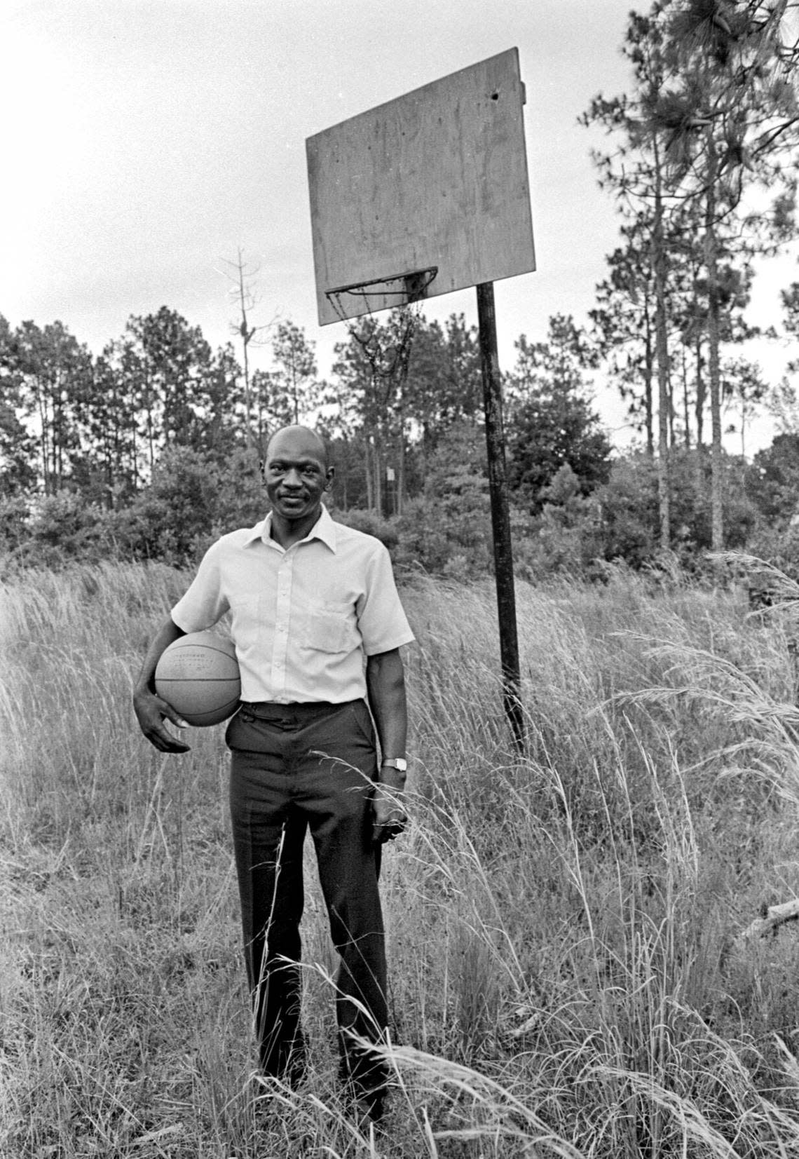 A 1984 photo shows James Jordan, the late father of basketball superstar Michael Jordan, standing by the old basketball goal beside the house where Jordan grew up in Wilmington, N.C.