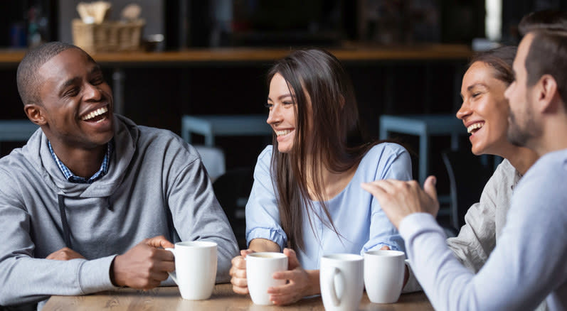 friends laughing at a coffee shop