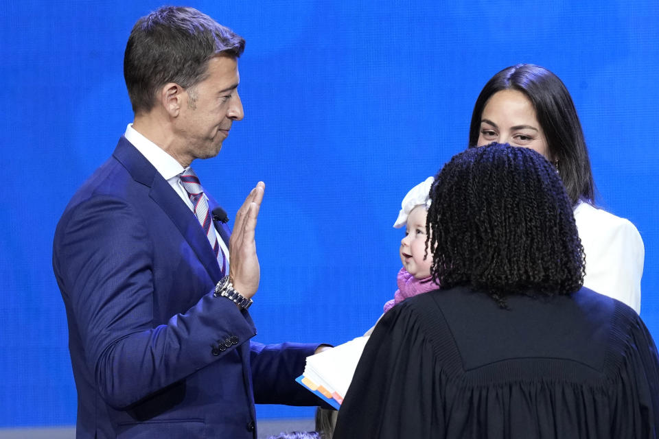 Newley elected Illinois Secretary of State Alexi Giannoulias takes the oath of office from Joy V. Cunningham, Illinois Supreme Court Associate Justice as his family watches during ceremonies Monday, Jan. 9, 2023, in Springfield, Ill. (AP Photo/Charles Rex Arbogast)