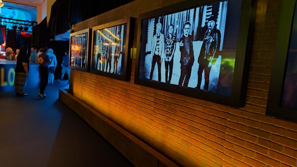 A series of classic Anton Corbin photos of U2 line the hallway of Zoo Station: A U2:UV Experience at The Venetian Resort Las Vegas.