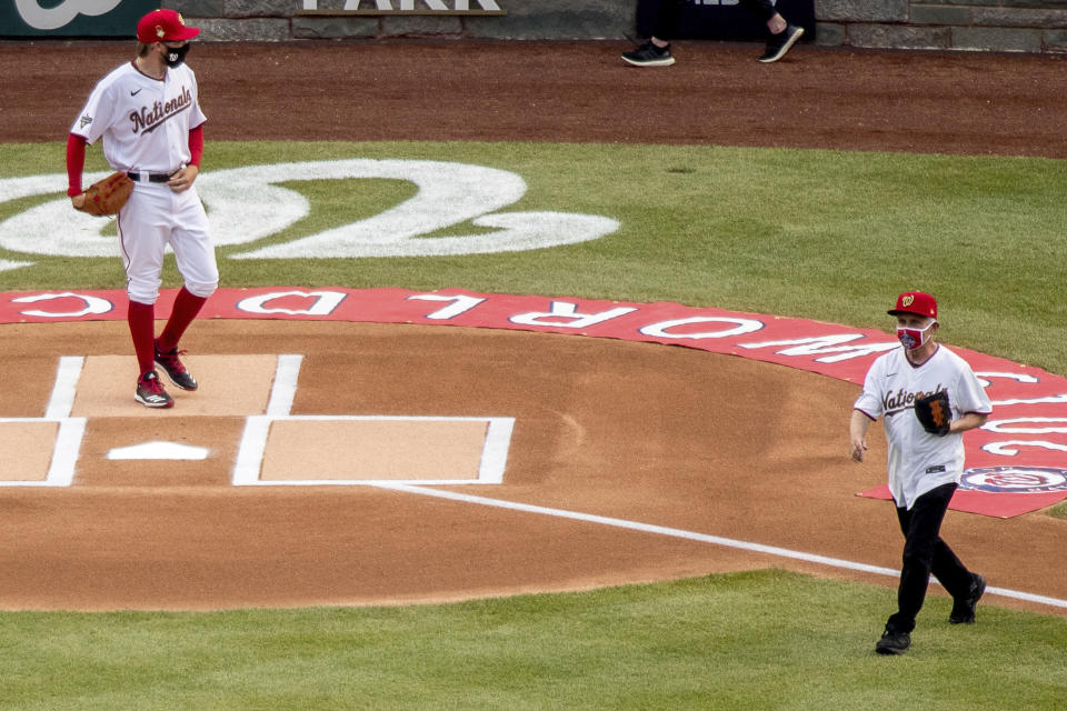 Dr. Anthony Fauci walks to the mound in Nationals gear while Sean Doolittle awaits at the plate. 