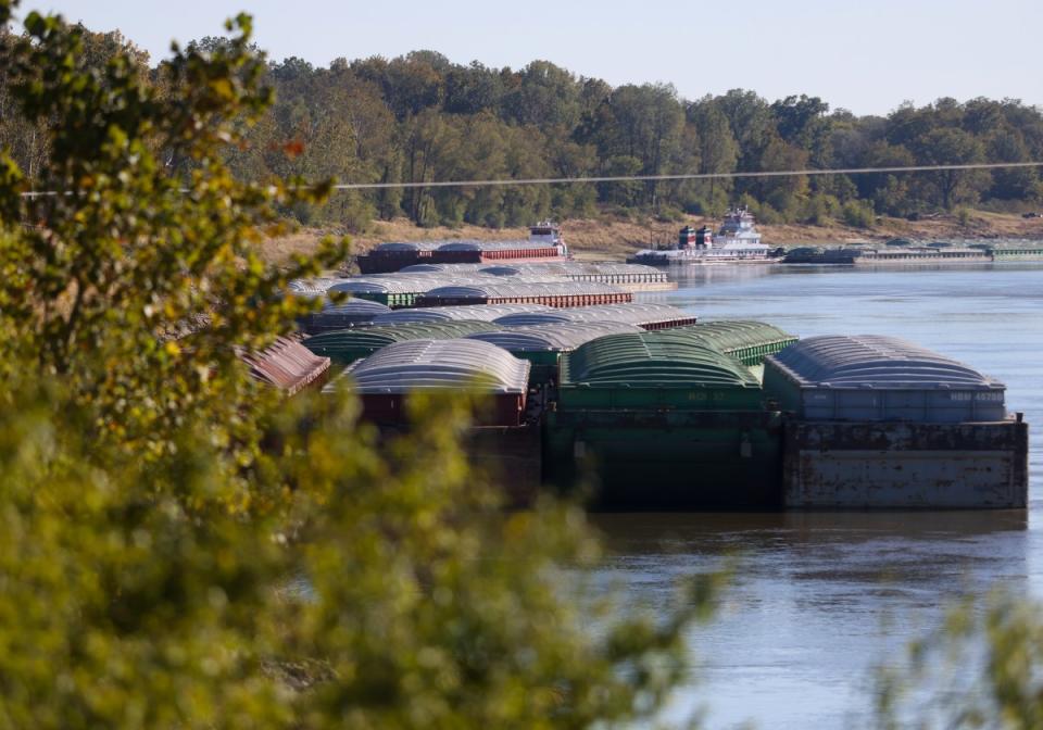 Barges on the Mississippi River sit on the other side of the levee from Mayersville, Miss., which lacks a port despite locals’ desire to develop one.