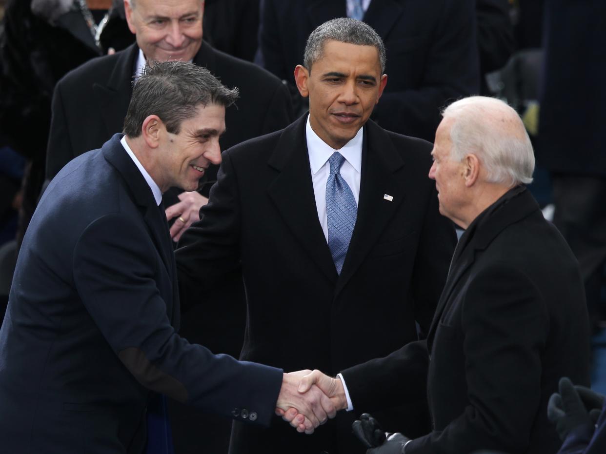 Richard blanco is greeted by then-Vice President Joe Biden and then-President Barack Obama after reciting his poem during the presidential inauguration on 21 January 2013 at the US Capitol in Washington, DC (Mark Wilson/Getty Images)