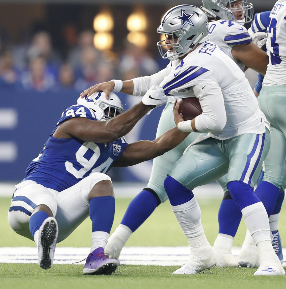<p>Indianapolis Colts defensive end Tyquan Lewis (94) takes down Dallas Cowboys quarterback Dak Prescott (4) for a first half sack on Sunday, Dec. 16, 2018 at Lucas Oil Stadium in Indianapolis, Ind. (Sam Riche/TNS) </p>