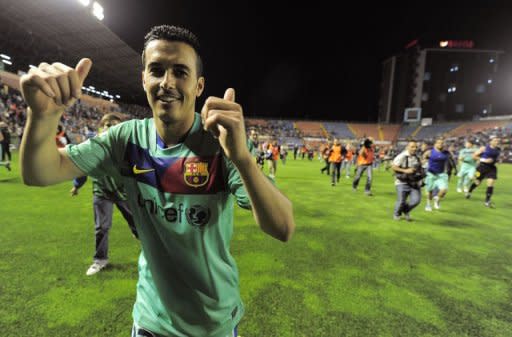 Barcelona's forward Pedro Rodriguez celebrates after the Spanish League football match against Levante at Ciutat de Valencia stadium in Valencia. Barcelona were crowned Spanish champions for the third successive season with a 1-1 draw at Levante clinching a 21st domestic title with two games to spare