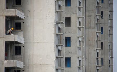 A man works at the construction site of residential highrises in Beijing, China June 27, 2017. REUTERS/Thomas Peter