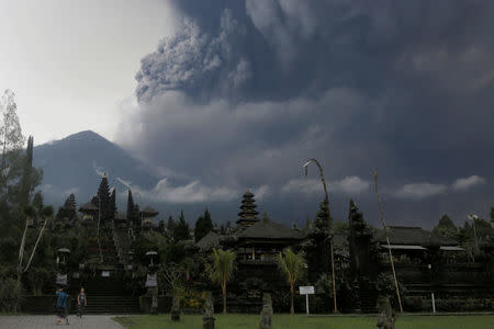 Foreign tourists take pictures as Mount Agung erupts at Besakih Temple in Karangasem, Bali, Indonesia on November 26, 2017. REUTERS/Johannes P. Christo