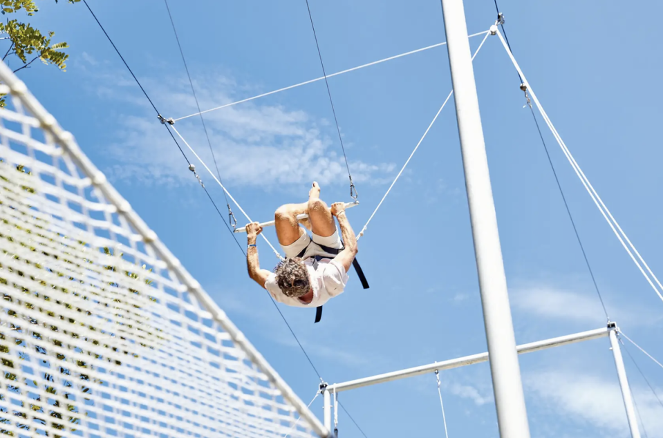 The resort’s playground, designed by Cirque du Soleil, includes a flying trapeze for kids and grown-ups alike (Club Med)