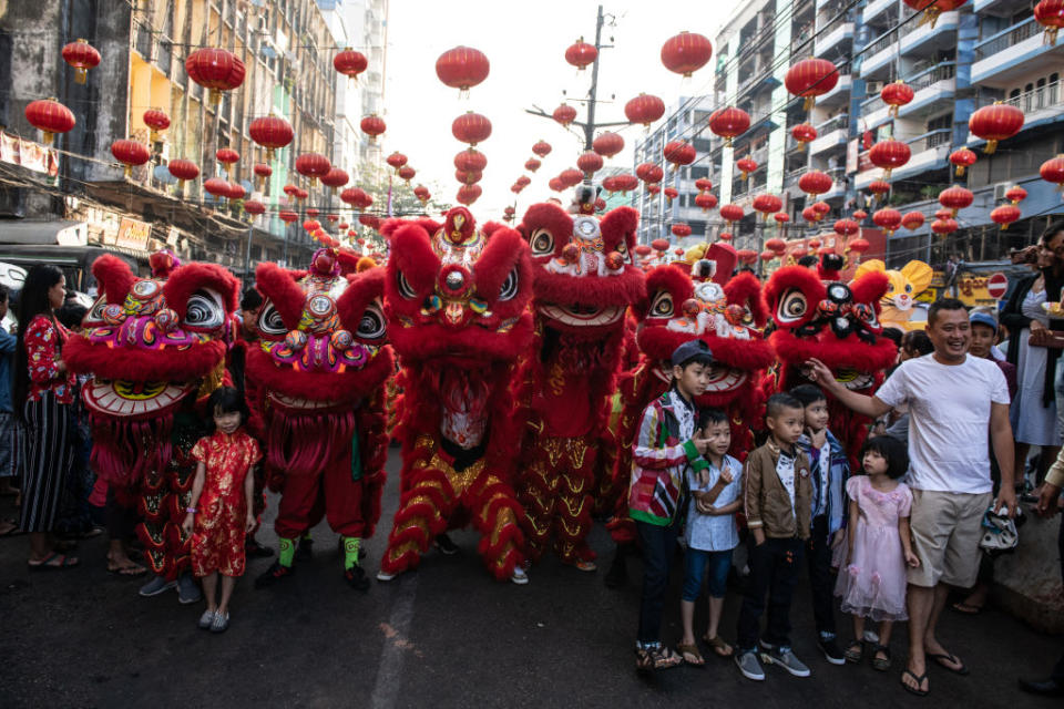 Children take a photograph wiht lion dancers during a ceremony to mark the first day of the Lunar New Year in Yangon's Chinatown on January 25, 2020.    Chinese New Year, also known as Lunar New Year or Spring Festival is most important festival for Chinese people.       (Photo by Shwe Paw Mya Tin/NurPhoto)