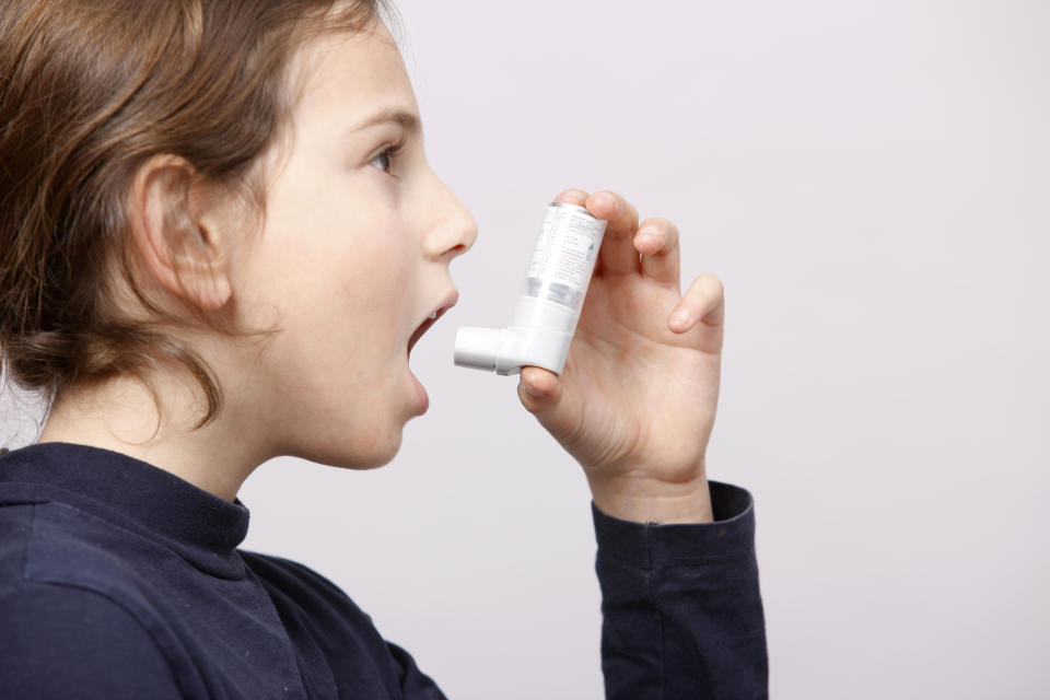 Child with asthma using puffer. Children have smaller lungs and less developed airways. (Getty)