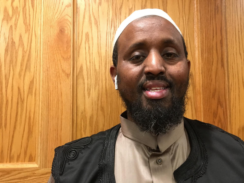 Mohamed Omar, executive director of Dar Al-Farooq Islamic Center, poses for a portrait in Bloomington, Minn. on Thursday, Oct. 25, 2018. The center was bombed just before morning prayers when the attackers broke a window to the imam's office and threw a pipe bomb containing black powder inside, sparking a fire that caused extensive damage. Three men from Illinois were charged in the attack; according to charges, one of them said the purpose was to "scare" Muslims out of the United States. Omar said the new mail-bomb case and the attack on his mosque were both intended to "create fear and terrorize people." (AP Photo/Amy Forliti)