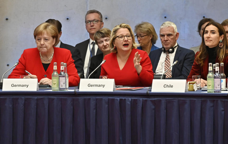 German Chancellor Angela Merkel, from left, and German Environment Minister Svenja Schulze and Chilean Environment Minister Carolina Schmidt attend the 10th Petersberger Klimadialog climate conference in Berlin, Germany, Tuesday, May 14, 2019. (Tobias Schwarz/Pool via AP)