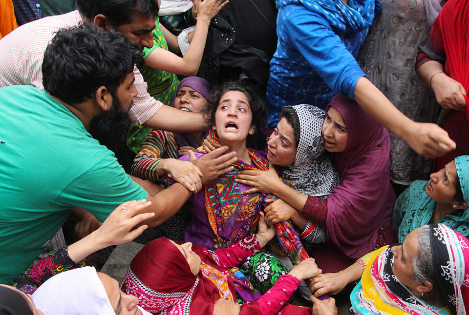 <p>Mehvish (C), sister of Irfan Ahmad, who was killed by a teargas canister fired by Indian security forces, mourns during a protest in Srinagars Fateh Kadal, Kashmir, India on August 22, 2016. (Faisal Khan/Anadolu Agency/Getty Images) </p>