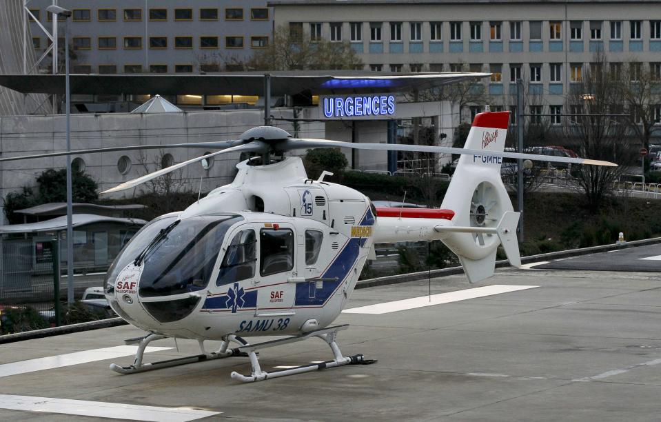 An helicopter stands outside the CHU Nord hospital in Grenoble, French Alps, where retired seven-times Formula One world champion Michael Schumacher is reported to be hospitalized after a ski accident, December 29, 2013. Schumacher suffered a head injury in a fall while skiing off-piste in the French Alps resort of Meribel on Sunday, an official said. The 44-year-old German was wearing a helmet and was conscious while being transported to a local hospital before later being transferred to to a better-equipped medical unit in Grenoble for further examinations. (REUTERS/Robert Pratta)