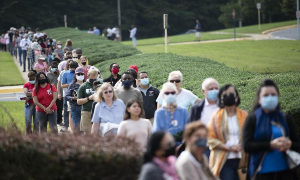 Voters line up to vote during in-person early voting in Fairfax, Virginia on 18 September 2020.