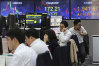 Currency traders talk on the phones at the foreign exchange dealing room of the KEB Hana Bank headquarters in Seoul, South Korea, Wednesday, April 29, 2020. Asian stock markets gained Wednesday after France and Spain joined governments that plan to ease anti-virus controls and allow businesses to reopen. (AP Photo/Ahn Young-joon)
