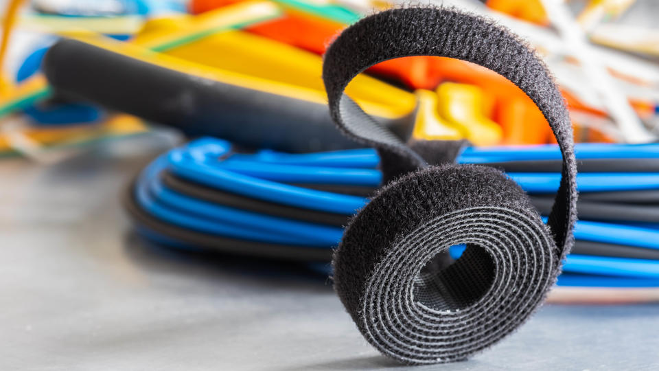 A roll of hook-and-loop fastener being used to organize cables