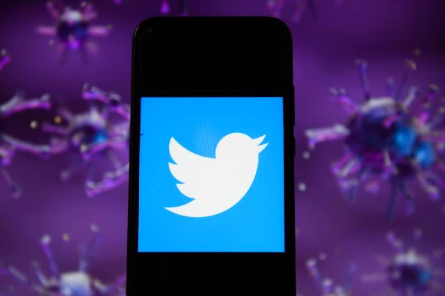 POLAND - 2020/04/28: In this photo illustration a Twitter logo displayed on a smartphone with a COVID 19 sample image in the background. (Photo Illustration by Omar Marques/SOPA Images/LightRocket via Getty Images)