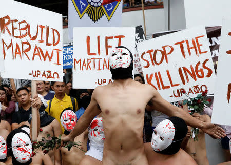 Naked mebers of the Alpha Phi Omega (APO) fraternity wearing masks attend a protest against extrajudicial killings and the lifting of martial law in the southern island of Mindanao, at the University of the Philippines in Quezon city, Metro Manila, Philippines December 1, 2017. REUTERS/Dondi Tawatao