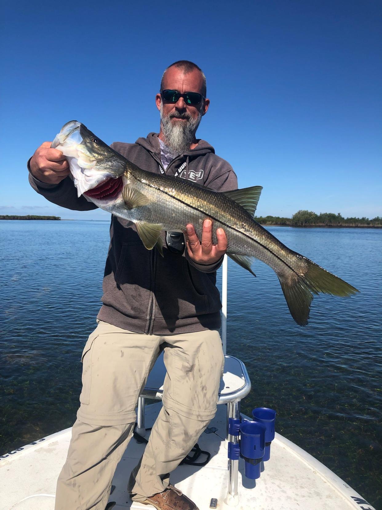 Capt. Eric Norberg holds up a beautiful 29” Snook, caught in a secret spot while fishing for redfish and seatrout.